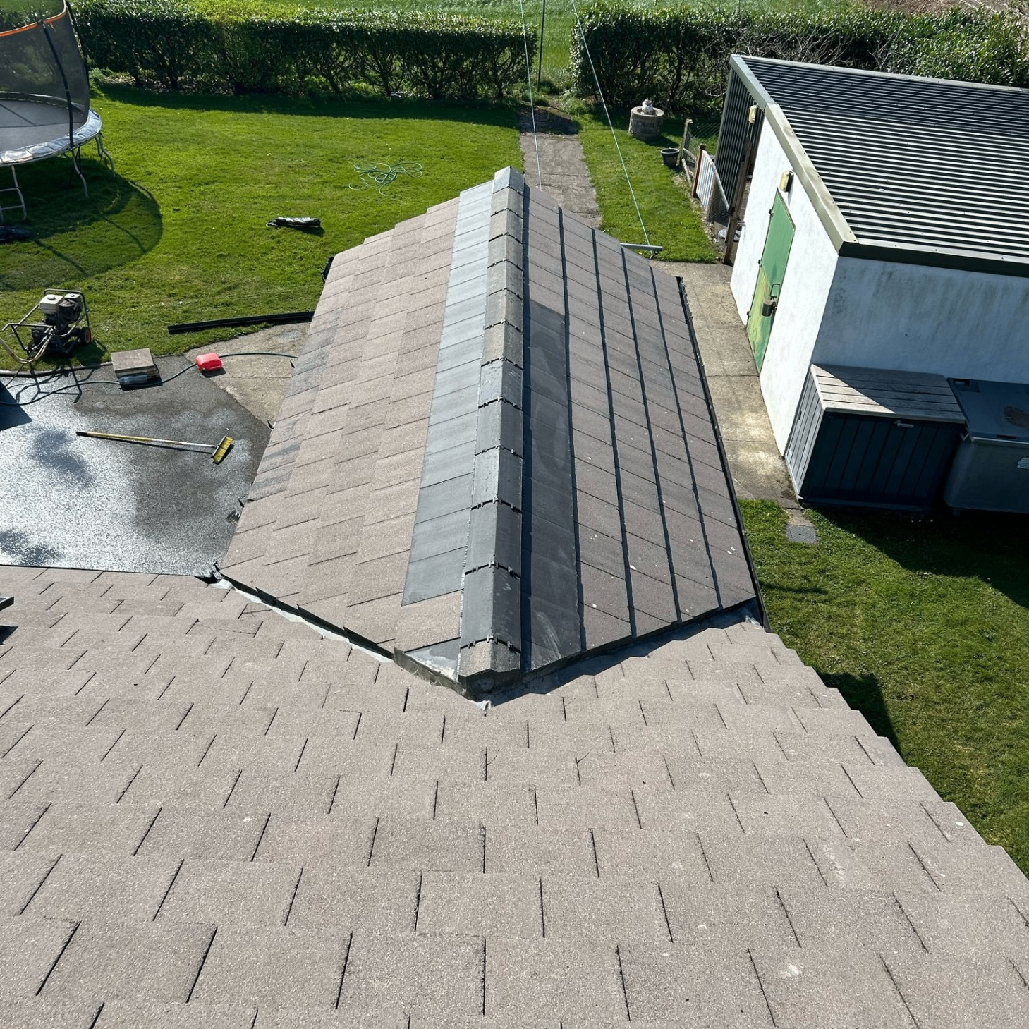 High-angle view of a smaller roof section and garage area