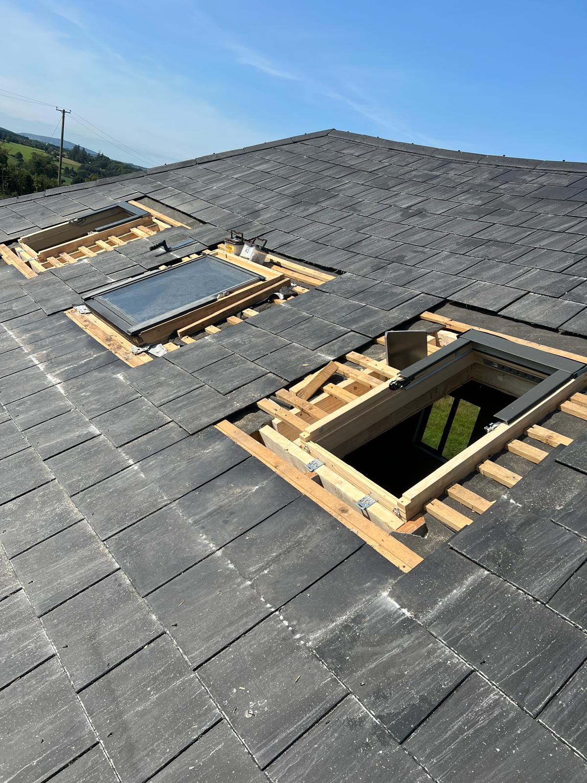 Roof windows being installed into a slate roof